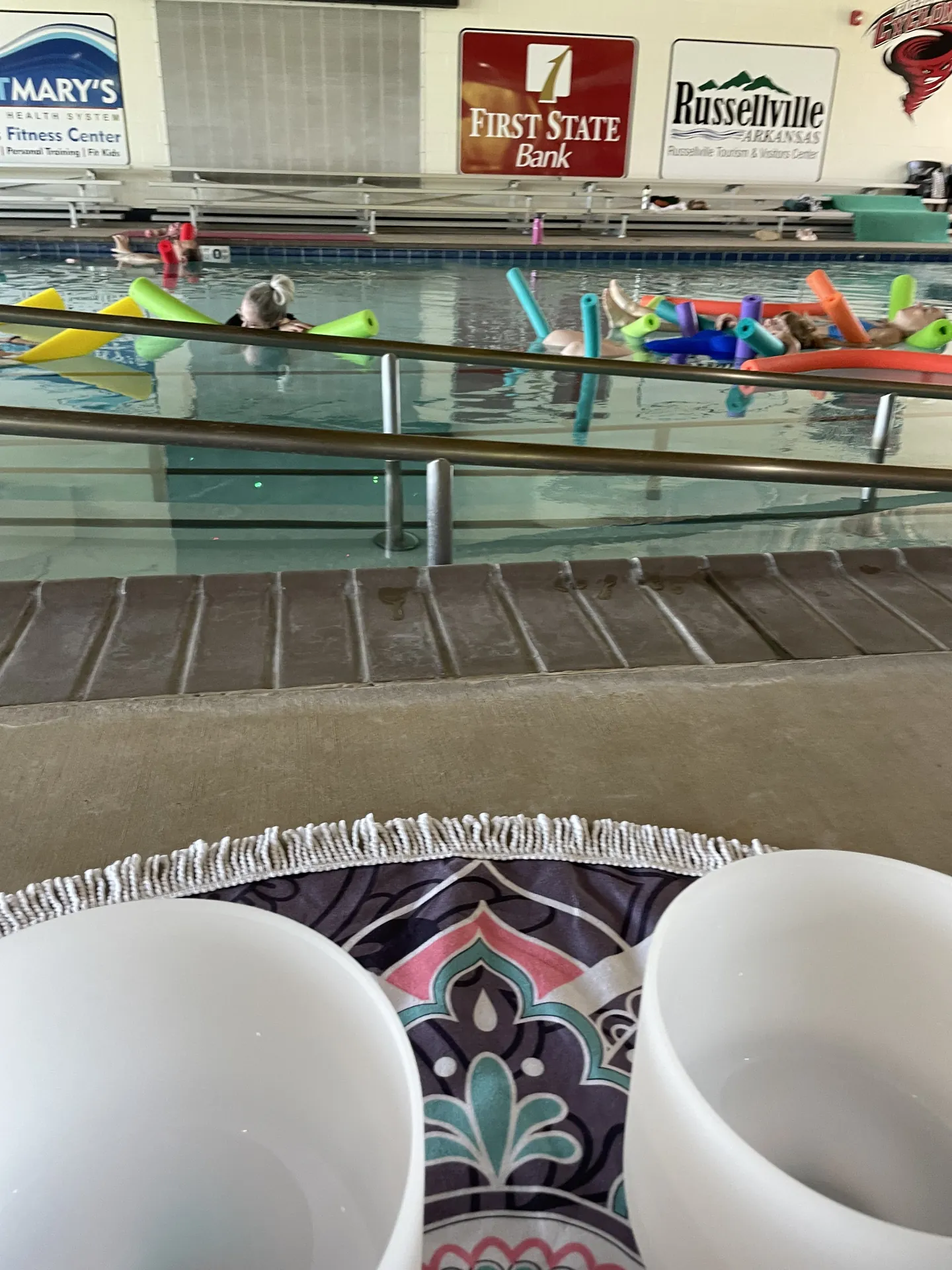 Crystal singing bowls set up poolside for a water sound bath at the Russellville Aquatic Center.