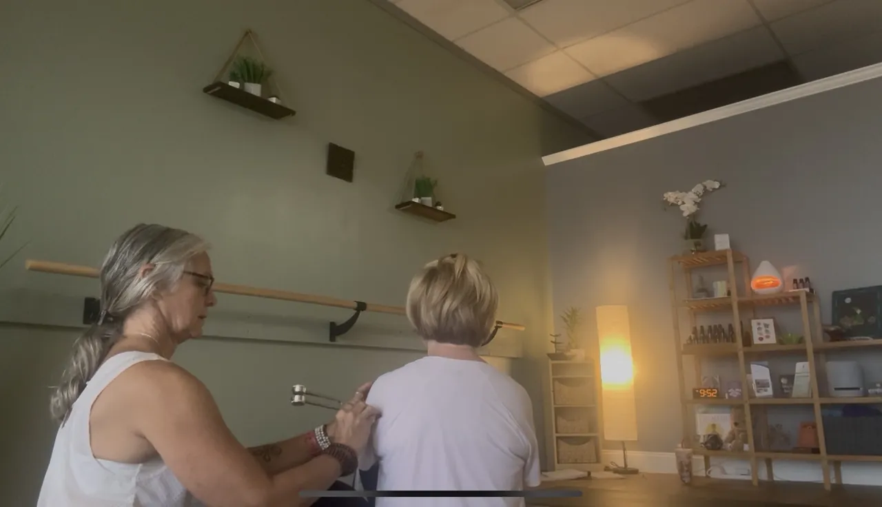 Jill working hands-on with a seated client during an individual session.