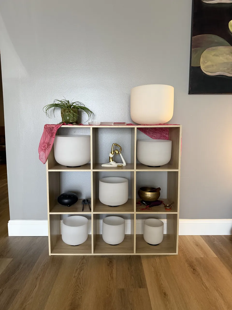 Crystal singing bowls stored on a cubby shelf in the studio.