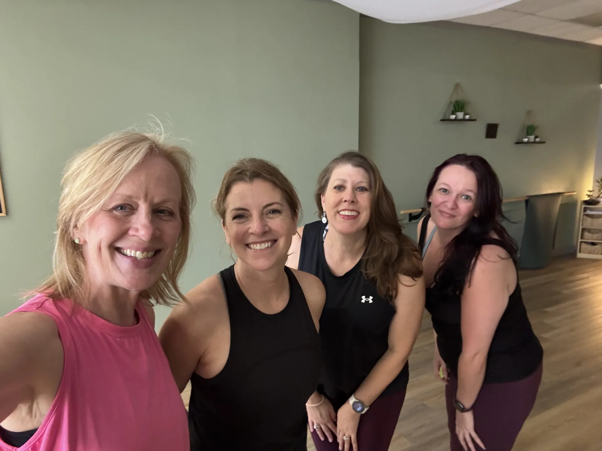 Four smiling students after class.